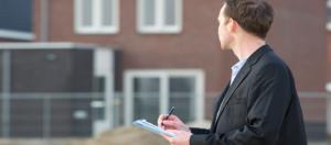 inspector appraising an home standing outside Turner Home Appraisals Denver